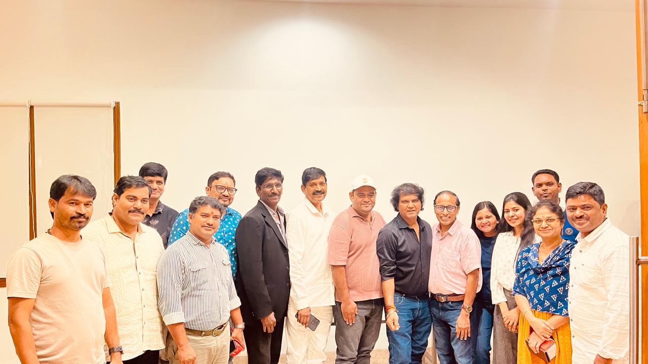 A group photograph of the programme's team and supporters